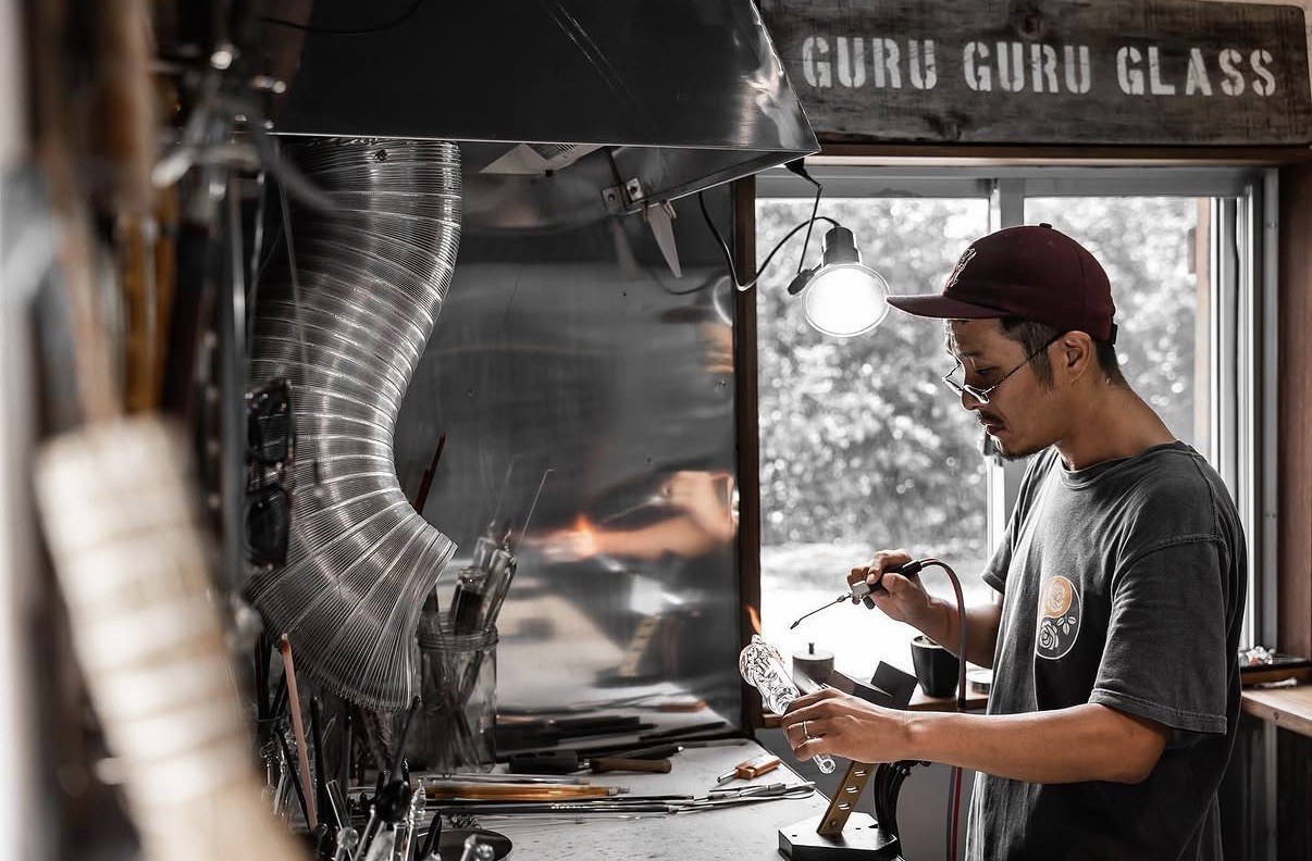 Makoto making glass inside the Guru Guru Glass workshop