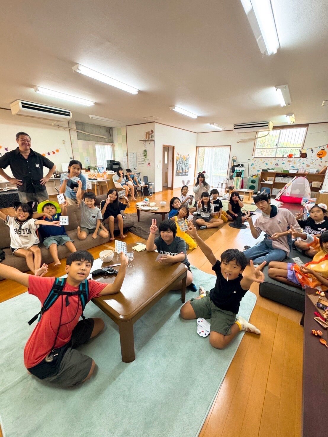Children gathering in a warm Miyakojima community room