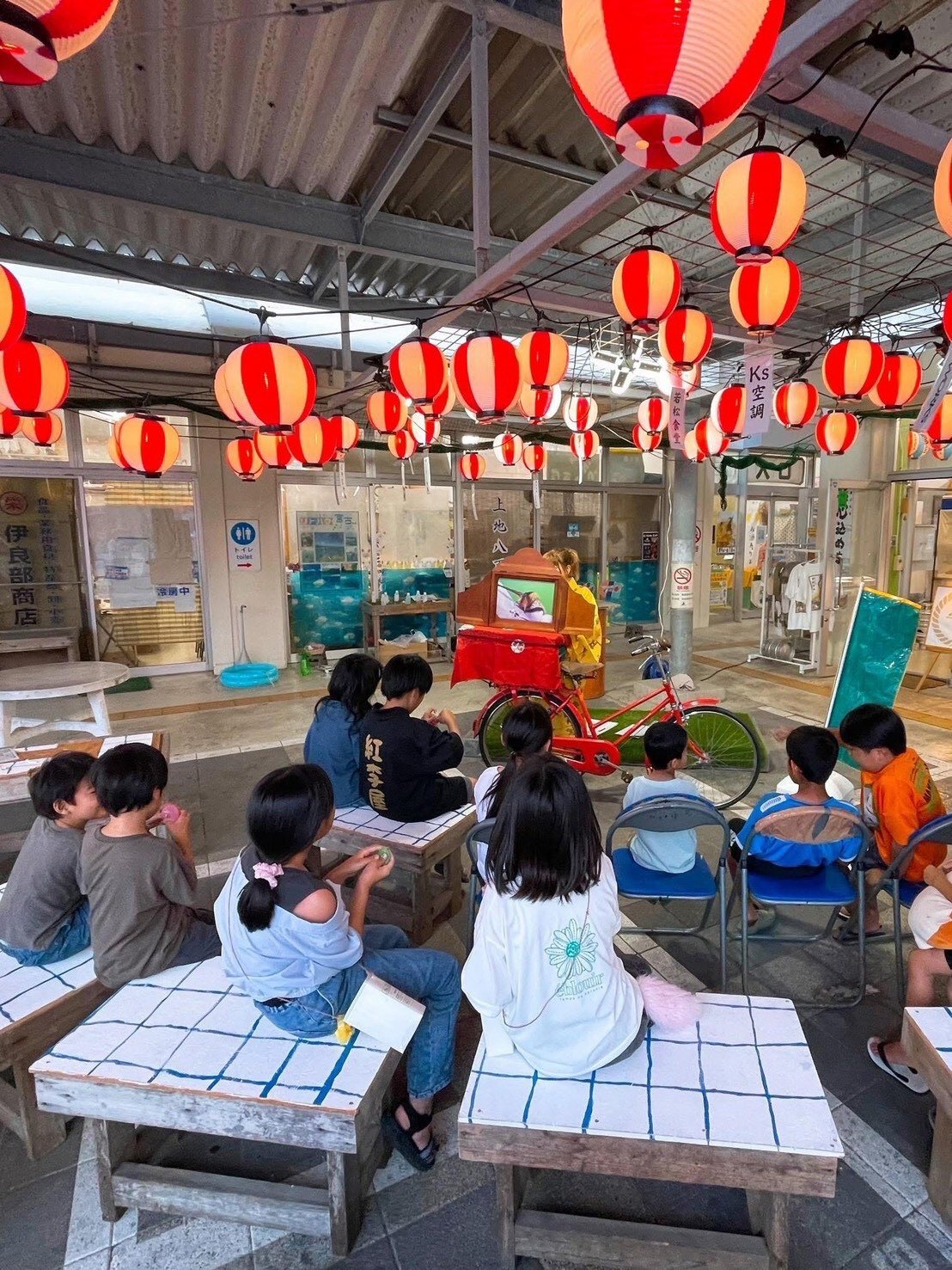Children watching kamishibai at a local event