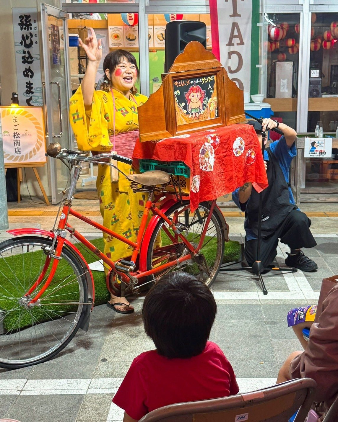 Kamishibai storytelling by bicycle at a Miyakojima market