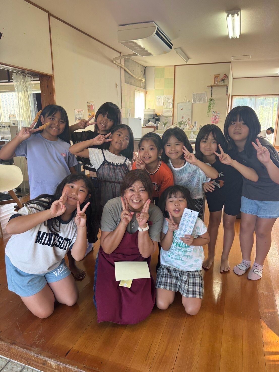 Tomoko-san with children at a community space in Miyakojima